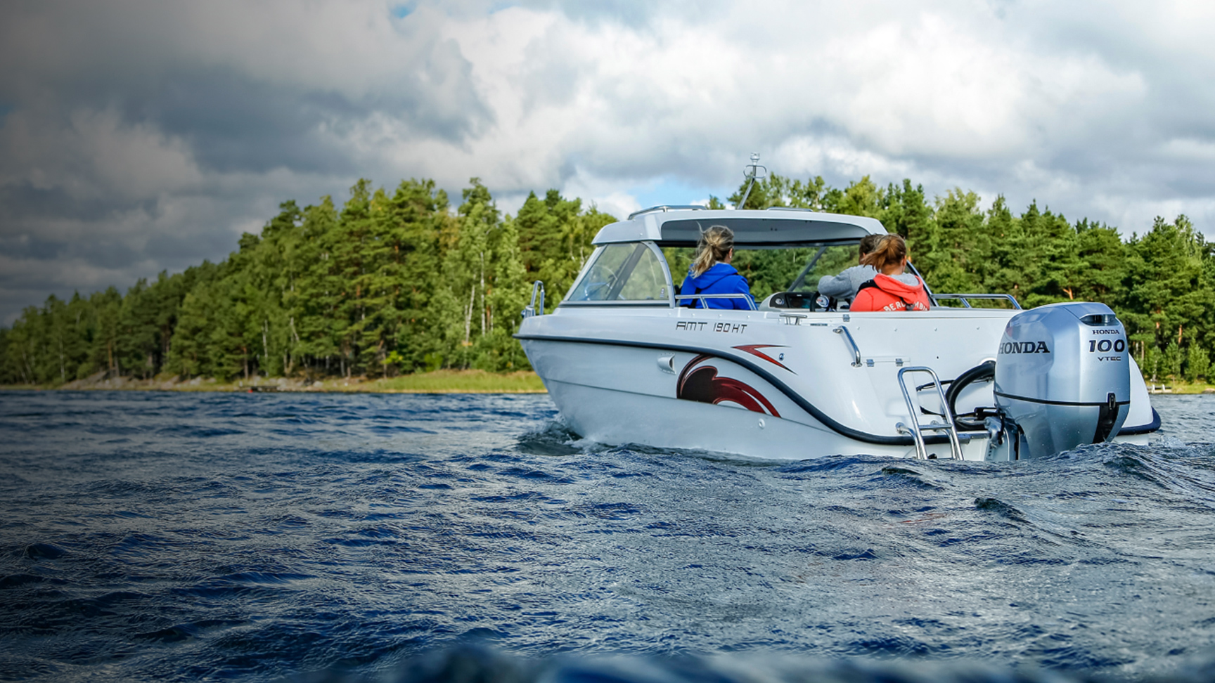 Famille sur un bateau au bord d’un lac utilisant un moteur Honda BF80-100. 