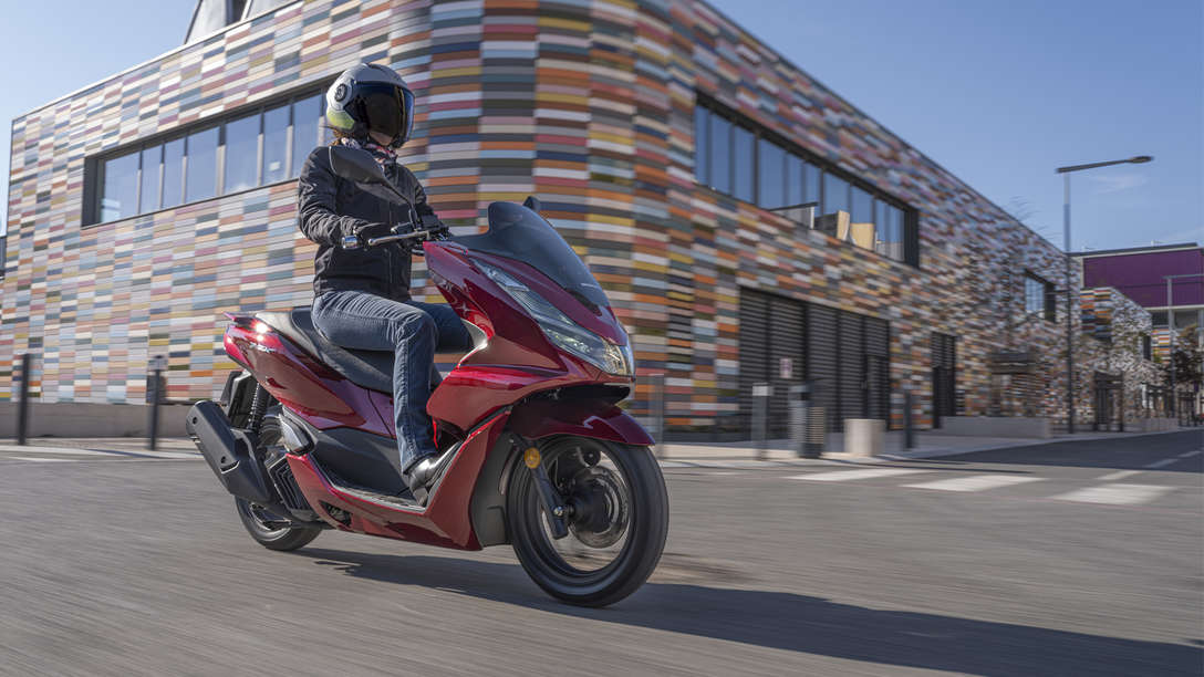 Honda PCX being ridden on street